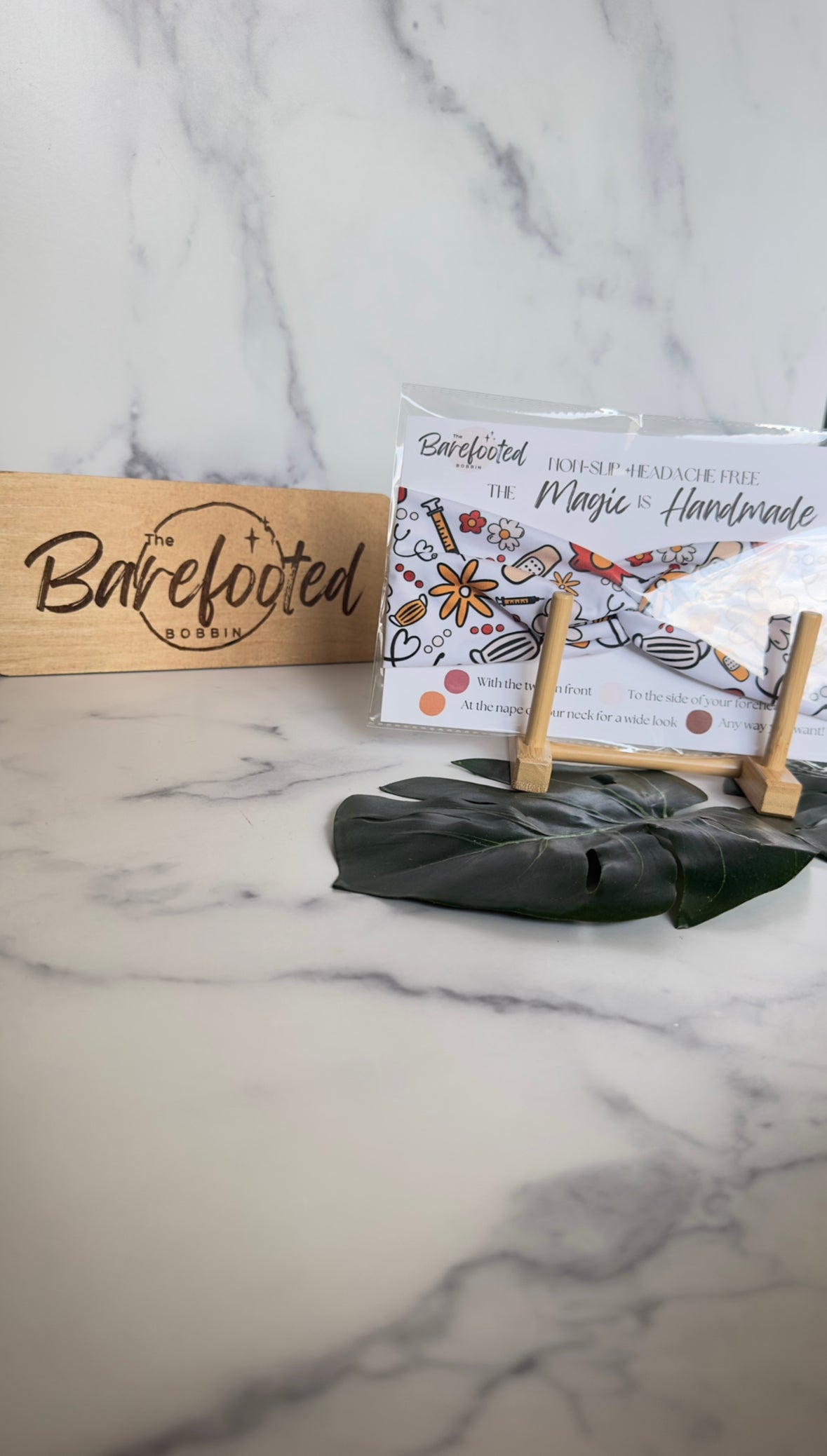 A white headband with fall colored flowers and various medical supplies- bandaids, masks, needs, etc